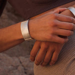 Das Dune Bracelet in Silber ist ein Piece of Art für das Handgelenk. Die wellenartigen Strukturen erzählen von Sediment, von Sanddünen und vom Meeresboden